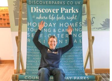 Happy team member on giant deck chair